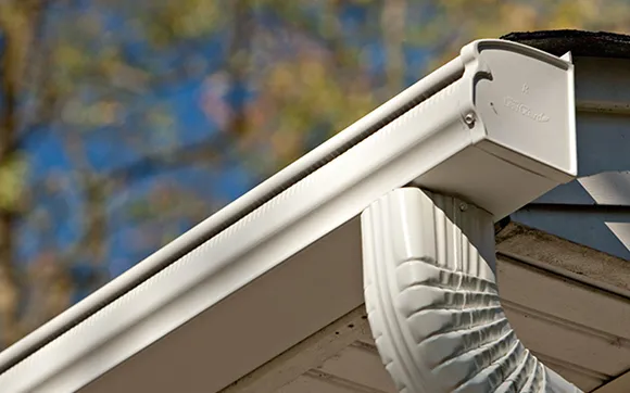Close-up of white gutter and downspout on a residential home in Stoughton, MA